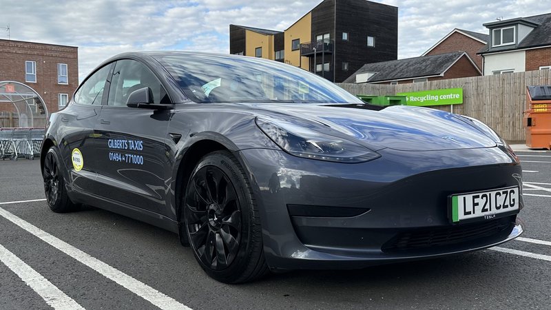 A Gilberts electric Tesla taxi with green number plate